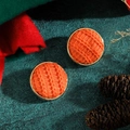 Macro detail of orange knit button earrings with gold metal frame on a green background - Orange Knit (Style 12)