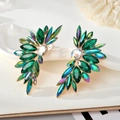 Detail of gold-tone wing earrings with marquise-cut green crystals and sparkling gems - Gold Base Colorful