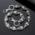 Close-up of silver punk skull link chain with lobster clasp on reflective black background - Gunmetal Gray Skull Head