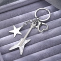 Silver guitar keychain with white enamel star charm and heart clasp on velvet background - Silver