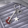 Detailed macro view of Y2K style guitar keychain with a silver star and heart-shaped clasp - Burgundy