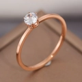 Elegant rose gold solitaire ring with six-prong crown setting on a jewelry box - US 6 / Classic Six-Prong Style / Rose Gold