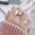 Close-up of rose gold Roman numeral ring with black enamel inlay worn on finger - US 5 / Rose Gold Black Ceramic