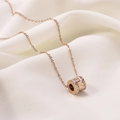 Detail of rose gold cylinder pendant with double-row crystals and Roman numerals - Roman Numeral Double Ring / Rose Gold