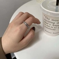 Close-up of a silver titanium steel ring with sparkling center band on a finger - US 5 / Inlaid Frosted Silver