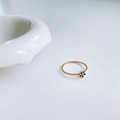 Anello minimalista a margherita in oro rosa con fiore nero su sfondo bianco pulito - US 4 / Margherita in Smalto Nero / Oro rosa
