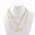 Close-up of layered gold coin necklace with chunky curb chains and vintage portrait pendant - Triple Layer Portrait Coin Style (NXN01987) / Gold