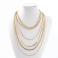 Detail of layered gold necklaces with curb, snake and paperclip chains on model - Six Layer Multi Chain Style (NTN01967) / Gold