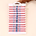 Set di 12 braccialetti in corda rossa intrecciata con perline malocchio su cartoncino - Braccialetti Tre Occhi Corda Rossa