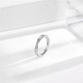 Elegant silver stainless steel crisscross ring with pavé crystals on a white stone base - US 5 / Silver