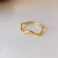 Detailed view of wave-shaped golden titanium steel ring with elegant polished finish - US 5 / Gold