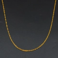 Detailed macro view of a thin golden water wave chain necklace with metallic luster - Water Wave Chain (Style 3)