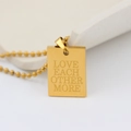 Macro shot of gold square pendant with engraved Love Each Other More text on bead chain - LOVE EACH OTHER MORE (New)