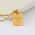 Detailed macro view of gold plated pendant necklace with More Self Love engraving - MORE SELF LOVE (New)
