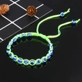 Detail view of neon green braided evil eye bracelet featuring vibrant blue protective beads - Neon Green (B0042)