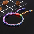 Colorful handmade braided Evil Eye bracelet with adjustable cord on reflective black surface - Rainbow (B0041)