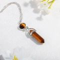 Macro shot of tiger eye stone pendant featuring a hexagonal pillar and round silver chain - Brown (N0279)