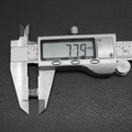 Macro shot of 7.79mm vintage silver bead being measured with a digital caliper - Vintage Embossed Round Charm (P0897) / Antique Silver
