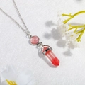 Detailed close-up of pink round stone and red crystal hexagonal prism pendant on silver chain - Red (N0280)