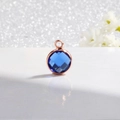 Detail of blue birthstone pendant with rose gold plating on a white elegant background - Rose Gold-Dark Blue (December)