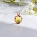 Detail of round yellow gemstone pendant with rose gold frame and faceted crystal - Rose Gold-Light Yellow (November)