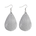 Detail showing silver teardrop earrings with textured wave patterns and fishhook clasps - Silver