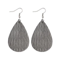 Detailed macro view of tear-drop faux leather earrings with silver metallic wavy texture - Gray