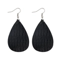 Close-up of black teardrop earrings featuring a vertical ripple leather texture and silver hooks - Black