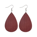 Detail view of burgundy teardrop earrings with embossed wave pattern on faux leather - Burgundy