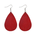 Detailed macro view of red water drop earrings with wave-textured faux leather patterns - Red