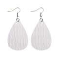 Detailed macro of white teardrop PU leather earrings with textured wave pattern - White