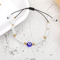 Detail of bohemian evil eye braided bracelet with white beads and adjustable gold beads - Gold Bead Solid White Eye (B2122)