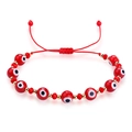 Close-up of red Evil Eye beads with golden spacers on a braided adjustable rope bracelet - Red Woven Style (B2741)