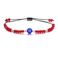 Detail of red crystal beaded bracelet with blue evil eye charm and adjustable cord - Steel Bead Red Royal Blue Eye (B2131)