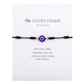 Pulsera de la suerte ojo turco azul con detalles dorados presentada en tarjeta - Cordón Negro (B2141)