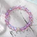 Detailed shot of purple iridescent beaded bracelet with a silver crystal pavé ball charm - Purple