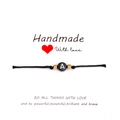 Pulsera artesanal de hilo negro letra A con cuentas doradas en tarjeta regalo - Letra A / Negro