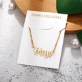 Detailed view of golden Virgo zodiac necklace on stainless steel chain with packaging - Virgo-Gold