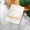 Close-up of Sagittarius golden stainless steel pendant necklace on jewelry display card - Sagittarius-Gold