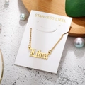 Macro shot of custom Liora name necklace in gold finish on stainless steel O-chain - Libra-Gold