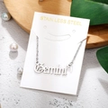 Detail of Gemini constellation pendant in silver stainless steel on product packaging - Gemini-Silver