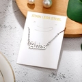 Macro shot of silver stainless steel Aries zodiac pendant necklace on a display card - Aries-Silver