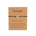 Handmade Scorpio zodiac bracelet with black woven cord and golden pendant on gift card - Gold Scorpio (B0863)