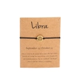Handmade black woven Libra zodiac bracelet with gold charm on kraft paper card - Gold Libra (B0848)