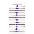 Dettaglio di 12 braccialetti intrecciati malocchio su carta da esposizione - Set Multi Cordino Nero Occhio Blu Perle Argento