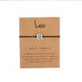 Handmade woven Leo zodiac bracelet with silver stainless steel charm on gift card - Silver Leo (B0797)