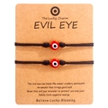 Detail of red Evil Eye beads on black braided cords presented on branded card stock - Red Bead Black Cord (B2936)