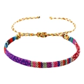 Detailopname van kleurrijke Boheemse geweven armband met verstelbare schuifknoop - Gekleurde Strepen (B2958)