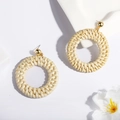 Close-up of handmade woven rattan hoop earrings with gold sphere studs in boho style - Hollow Circle