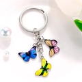 Detail view of colorful butterfly keychain with blue, orange, and yellow pendants - Blue Black Orange Pink Bright Yellow Butterfly Style (M743)